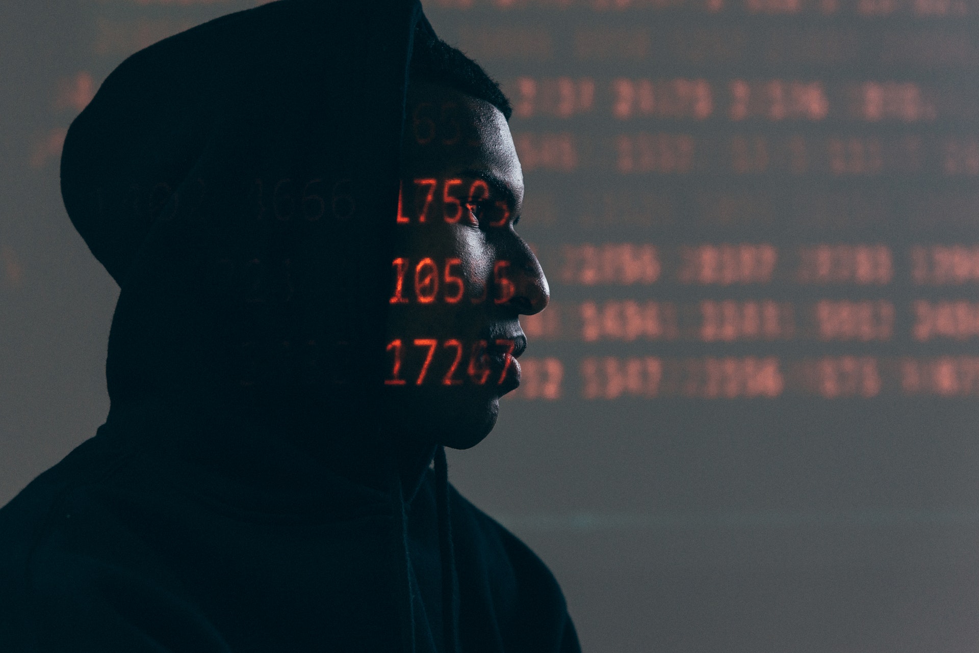 Hacker with red text projected onto face